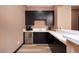 Wet bar area featuring dark cabinetry and stainless steel beverage fridge at 33 Desert Juniper Ln, Henderson, NV 89011