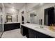 Elegant bathroom with dual vanities, dark cabinets and a shower with glass door at 33 Desert Juniper Ln, Henderson, NV 89011