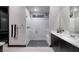Modern bathroom with a large glass shower, dark cabinets, and bright countertops at 33 Desert Juniper Ln, Henderson, NV 89011