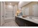 Well-lit bathroom featuring a vanity with dark cabinets and integrated tub-shower at 33 Desert Juniper Ln, Henderson, NV 89011