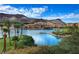 Picturesque lakeside community with Mediterranean-style buildings and palm trees against a mountain backdrop at 33 Desert Juniper Ln, Henderson, NV 89011