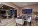 Dining room with outdoor patio access, stone wall feature, and modern furnishings at 33 Desert Juniper Ln, Henderson, NV 89011