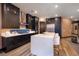 Modern kitchen featuring dark cabinets, white countertops, and stainless steel appliances at 33 Desert Juniper Ln, Henderson, NV 89011