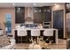 Modern kitchen featuring a large island, stainless steel appliances, and stylish bar stools at 33 Desert Juniper Ln, Henderson, NV 89011