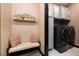 Laundry room with modern washer and dryer, ample storage and seating at 33 Desert Juniper Ln, Henderson, NV 89011