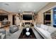 Spacious living room with fireplace, mounted TV, and open access to the kitchen at 33 Desert Juniper Ln, Henderson, NV 89011