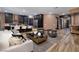 Open living space with modern furniture, sleek kitchen, and hardwood flooring at 33 Desert Juniper Ln, Henderson, NV 89011