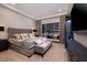 Luxurious main bedroom featuring a fireplace, a large window and upholstered furniture at 33 Desert Juniper Ln, Henderson, NV 89011