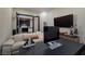 Modern home office with a sofa, large desk, and a view into the kitchen through glass doors at 33 Desert Juniper Ln, Henderson, NV 89011
