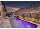 Inviting pool featuring a water feature and elegant landscaping at sunset at 33 Desert Juniper Ln, Henderson, NV 89011