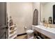Stylish powder room with gold fixtures and patterned wallpaper at 33 Desert Juniper Ln, Henderson, NV 89011