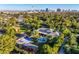 Expansive estate featuring a pool, sport court, lush greenery, and city views in the distance at 330 Rancho Cir, Las Vegas, NV 89107