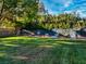 Expansive backyard with lush green grass, mature trees, and garden beds at 330 Rancho Cir, Las Vegas, NV 89107