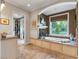Luxurious bathroom featuring a soaking tub with jets, a walk-in closet, and a large window overlooking the backyard at 330 Rancho Cir, Las Vegas, NV 89107