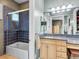 Bathroom with tiled shower, large mirror, and a vanity with counter space and cabinets at 330 Rancho Cir, Las Vegas, NV 89107