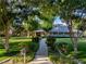 Stately home with a large front lawn, mature trees, and a welcoming walkway at 330 Rancho Cir, Las Vegas, NV 89107