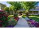 Charming home with lush landscaping, vibrant flowers, and a welcoming walkway at 330 Rancho Cir, Las Vegas, NV 89107