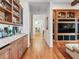 Hallway featuring a custom built-in bar with a marble countertop, wood cabinets, and a seating area at 330 Rancho Cir, Las Vegas, NV 89107