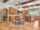 Open concept kitchen with stainless steel appliances, wood cabinets, granite counters and adjacent dining area at 330 Rancho Cir, Las Vegas, NV 89107