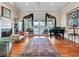 Bright living room boasts hardwood floors, a piano, and French doors overlooking the backyard at 330 Rancho Cir, Las Vegas, NV 89107