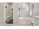 Bathroom showcasing a glass enclosed shower with bench, and soaking tub with decorative tile at 3409 Judson Ave, North Las Vegas, NV 89030
