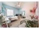 Shared bedroom with two twin beds, blue and pink walls, and bright, natural lighting at 3409 Judson Ave, North Las Vegas, NV 89030
