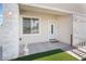 Charming front porch with stone accents, a white door, and a decorative rabbit statue at 3409 Judson Ave, North Las Vegas, NV 89030