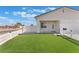 Inviting single-story home with a well-manicured artificial lawn and white picket fence at 3409 Judson Ave, North Las Vegas, NV 89030