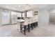 Bright kitchen boasts white cabinets, an island with bar seating, and modern stainless steel appliances at 3409 Judson Ave, North Las Vegas, NV 89030