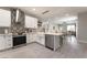 Open concept kitchen with white cabinets, stainless appliances, and dining area flows to the living room at 3409 Judson Ave, North Las Vegas, NV 89030