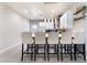 Modern kitchen featuring a breakfast bar with seating, white cabinetry, and pendant lighting at 3409 Judson Ave, North Las Vegas, NV 89030