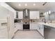 This kitchen features white cabinets, stainless steel appliances, and stylish backsplash at 3409 Judson Ave, North Las Vegas, NV 89030