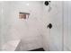 Shower featuring marble tiling, black hardware, and a built-in shelf for toiletries at 3409 Judson Ave, North Las Vegas, NV 89030