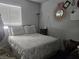 A serene bedroom with a bed and a sunburst mirror that adds character to the room at 3512 Trilogy Dr, Las Vegas, NV 89108