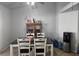 Simple dining area with a table, four chairs, and a display cabinet at 3512 Trilogy Dr, Las Vegas, NV 89108