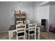 Simple dining area with a table, four chairs, and a display cabinet at 3512 Trilogy Dr, Las Vegas, NV 89108