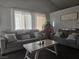 Bright living room with plush seating, a modern coffee table, and great natural light at 3512 Trilogy Dr, Las Vegas, NV 89108