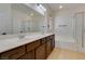 Bright bathroom offers double sink vanity, soaking tub, and separate shower stall at 3809 Alpine Track Ave, North Las Vegas, NV 89032