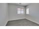 Neutral bedroom features gray carpet, white walls, and a window to the outside at 3809 Alpine Track Ave, North Las Vegas, NV 89032