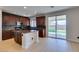 Modern kitchen with center island, wood cabinets, and stainless steel appliances. Access to the backyard at 3809 Alpine Track Ave, North Las Vegas, NV 89032