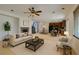 Inviting living room featuring a fireplace, ceiling fan, and open floor plan with lots of natural light at 3809 Alpine Track Ave, North Las Vegas, NV 89032