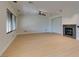 Spacious living room with neutral color palette, fireplace, ceiling fan, and hardwood flooring at 3809 Alpine Track Ave, North Las Vegas, NV 89032