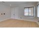 Neutral colored room featuring hardwood flooring and two large windows at 3809 Alpine Track Ave, North Las Vegas, NV 89032
