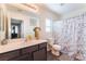 Clean bathroom with a large mirror, modern vanity, and stylish shower curtain at 4129 Chamisa Cove St, Las Vegas, NV 89115