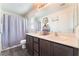 Well-lit bathroom with double sinks, modern fixtures, and spacious countertops at 4129 Chamisa Cove St, Las Vegas, NV 89115