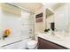 Bright bathroom with white tile shower, sliding glass doors, and modern vanity with sink at 4129 Chamisa Cove St, Las Vegas, NV 89115