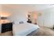 Comfortable bedroom with a white bed, dresser and neutral walls at 4129 Chamisa Cove St, Las Vegas, NV 89115