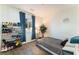 Cozy bedroom with a large window, shoe storage, and a neutral color palette at 4129 Chamisa Cove St, Las Vegas, NV 89115