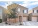 Charming two-story home featuring a well-manicured lawn, neutral stucco, and attached garage at 4129 Chamisa Cove St, Las Vegas, NV 89115
