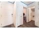 Inviting hallway with hardwood floors, white doors, and easy access to the bedroom and bathroom at 4129 Chamisa Cove St, Las Vegas, NV 89115